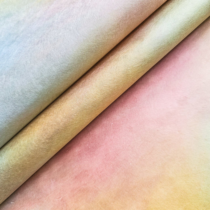 Close-up of Ombre handmade paper rolls from Kozo Studio featuring pastel gradients of yellow, pink, and peach, showcasing the soft texture and premium quality of mulberry paper.
