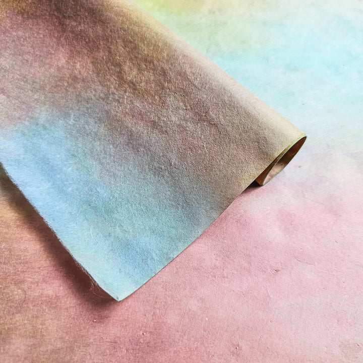 Detail view of pastel Ombre mulberry paper from Kozo Studio, highlighting the smooth gradient transition and delicate texture unique to artisan handmade paper.