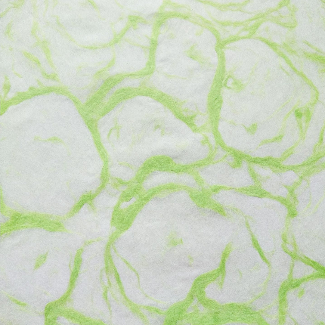 Detailed image of Ripple Kozo Paper from Kozo Studio, a handmade mulberry paper with green abstract designs over a soft white background.