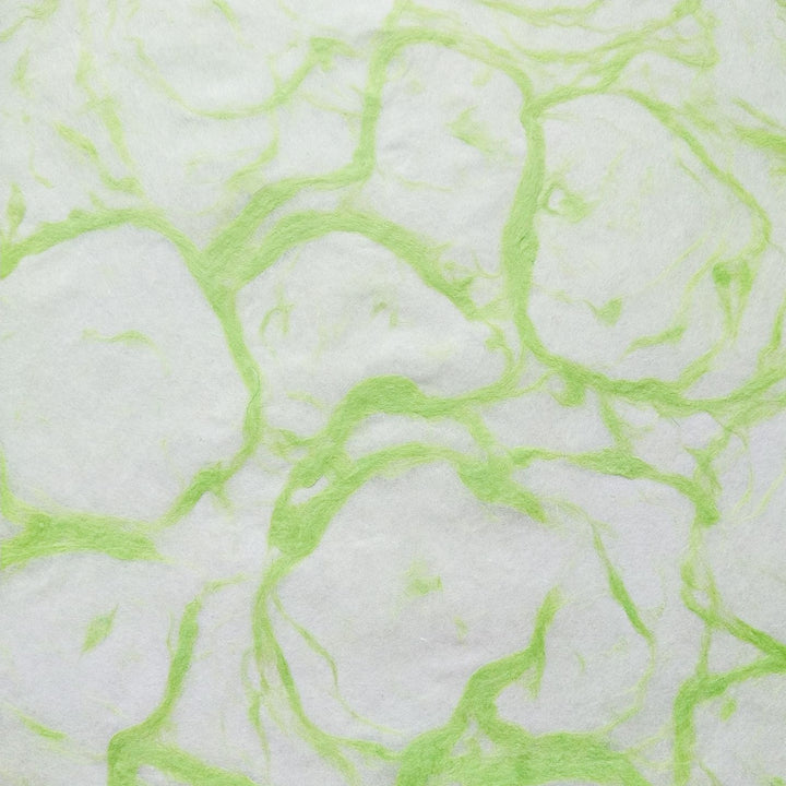 Detailed image of Ripple Kozo Paper from Kozo Studio, a handmade mulberry paper with green abstract designs over a soft white background.