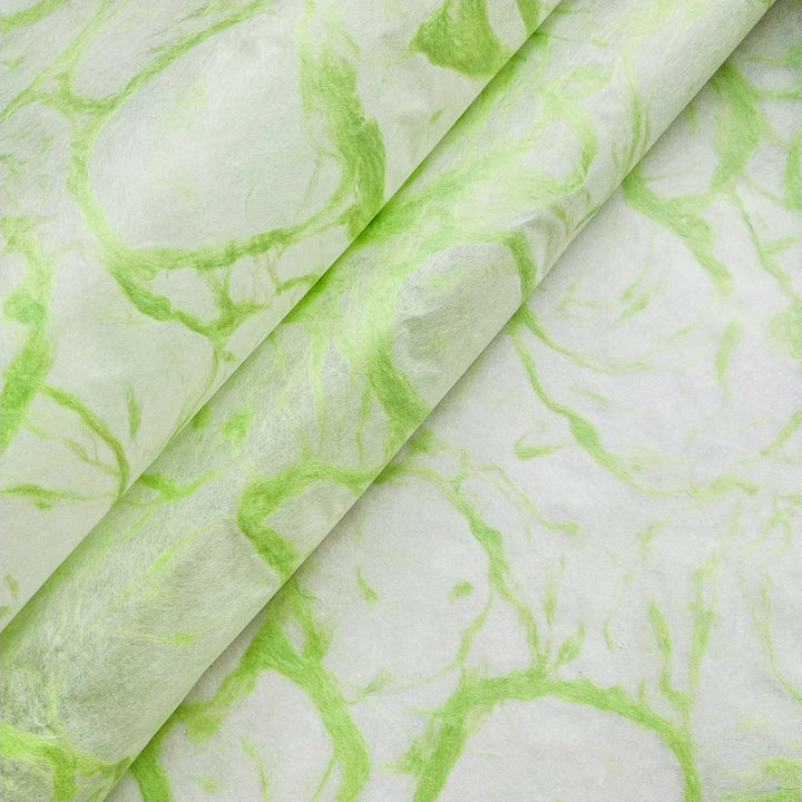 Ripple Kozo Paper from Kozo Studio shown close-up, revealing the intricate, marbled green design on thin, translucent handmade mulberry paper.