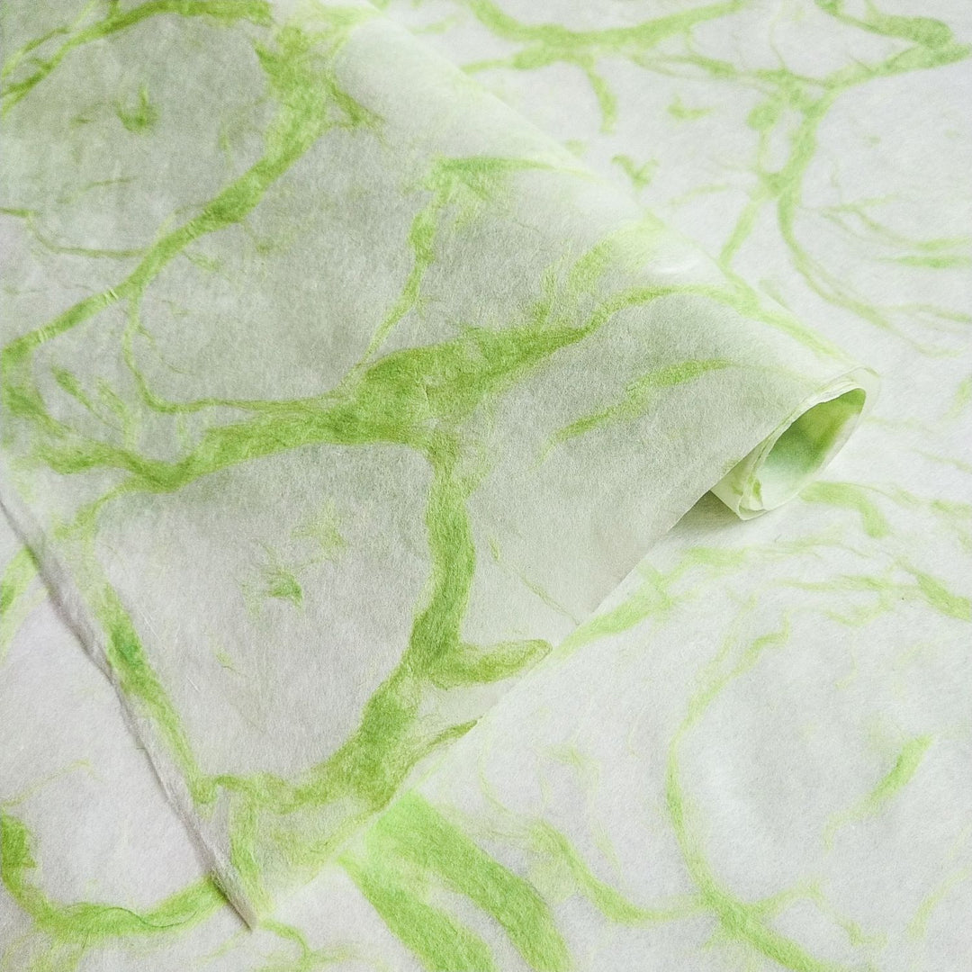 Handmade paper by Kozo Studio featuring Ripple Kozo Paper in green on white with delicate, smoke-like patterns on fine mulberry paper.