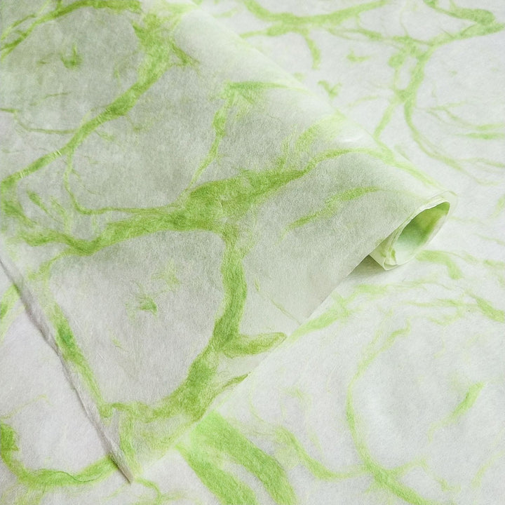 Handmade paper by Kozo Studio featuring Ripple Kozo Paper in green on white with delicate, smoke-like patterns on fine mulberry paper.