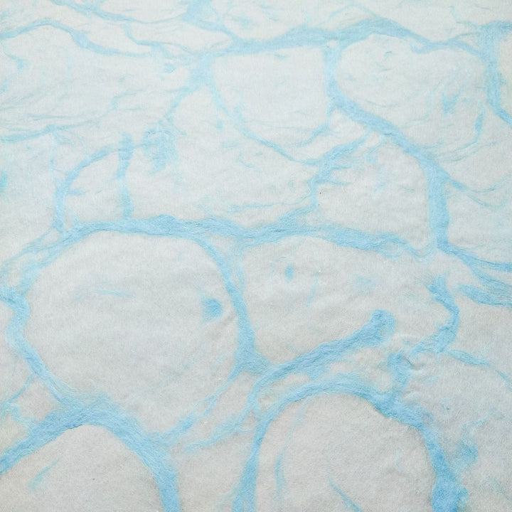 Artistic shot of Kozo Studio Ripple Kozo Paper in Blue on White, highlighting the subtle marbling and fine texture of traditional handmade mulberry paper.