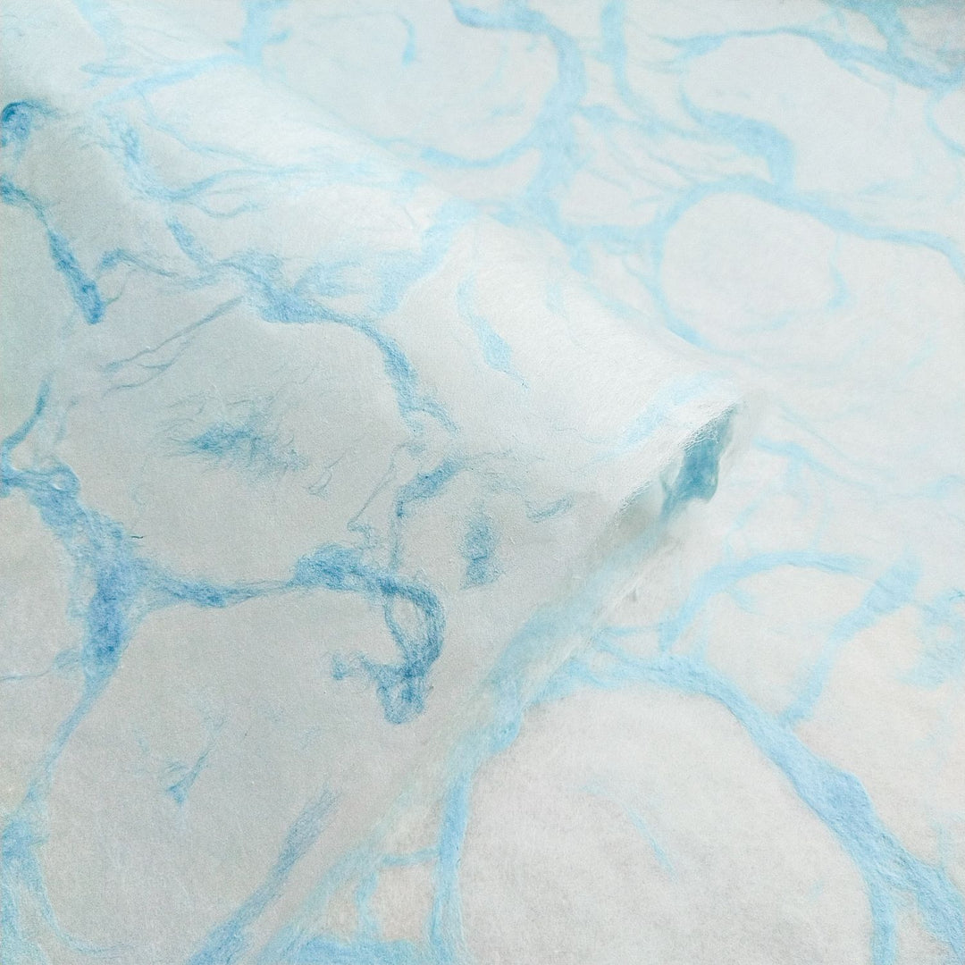 Ripple effect pattern in soft blue across Kozo Studio handmade mulberry paper, emphasizing the texture and beauty of Blue on White kozo paper.