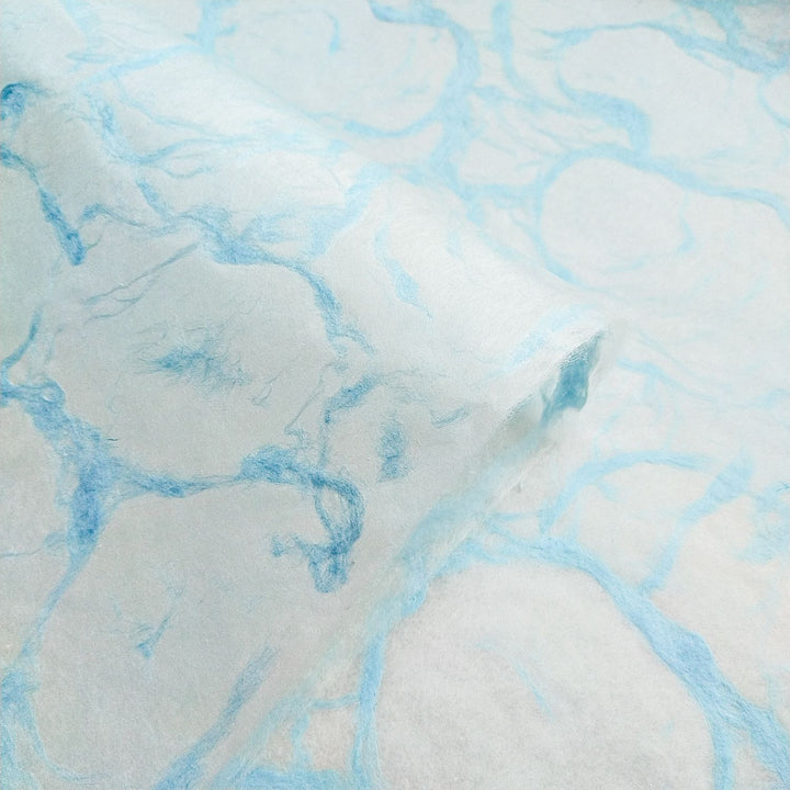 Ripple effect pattern in soft blue across Kozo Studio handmade mulberry paper, emphasizing the texture and beauty of Blue on White kozo paper.