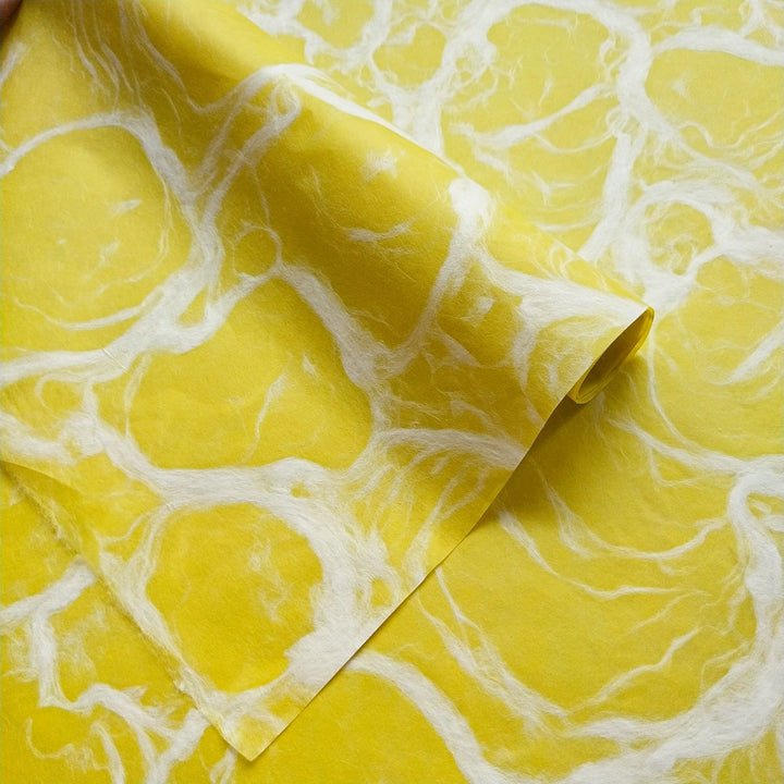 Handmade mulberry paper in Ripple Kozo style by Kozo Studio, displaying intricate white swirls over a bold yellow background