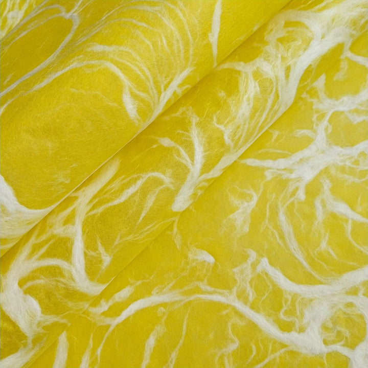 Detailed view of mulberry paper from Kozo Studio, showing marbled white patterns on vibrant yellow handmade Ripple Kozo paper.