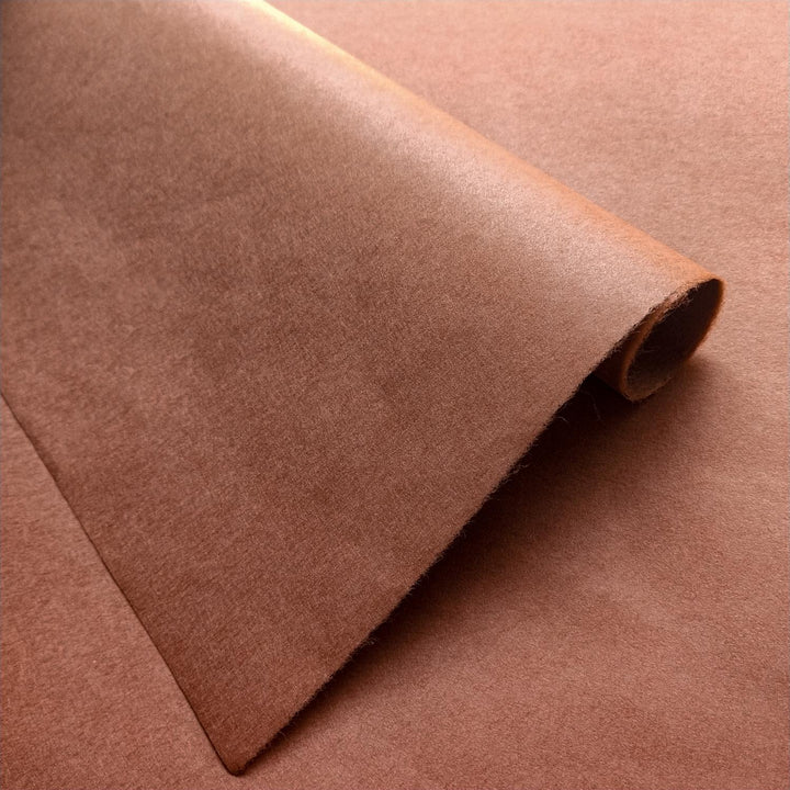 Amber brown handmade paper sheets from Kozo Studio, made with fine mulberry fibers and showcasing a smooth texture with subtle sheen.