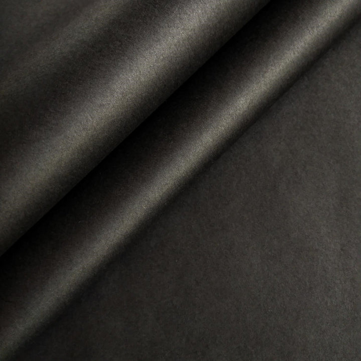 Close-up of black handmade mulberry paper by Kozo Studio showing smooth texture and natural folds.