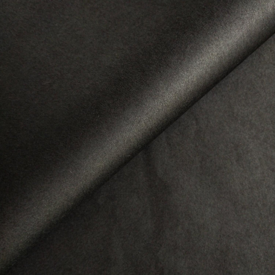 Close-up texture of black mulberry paper crafted by Kozo Studio with visible handmade paper creases and depth.