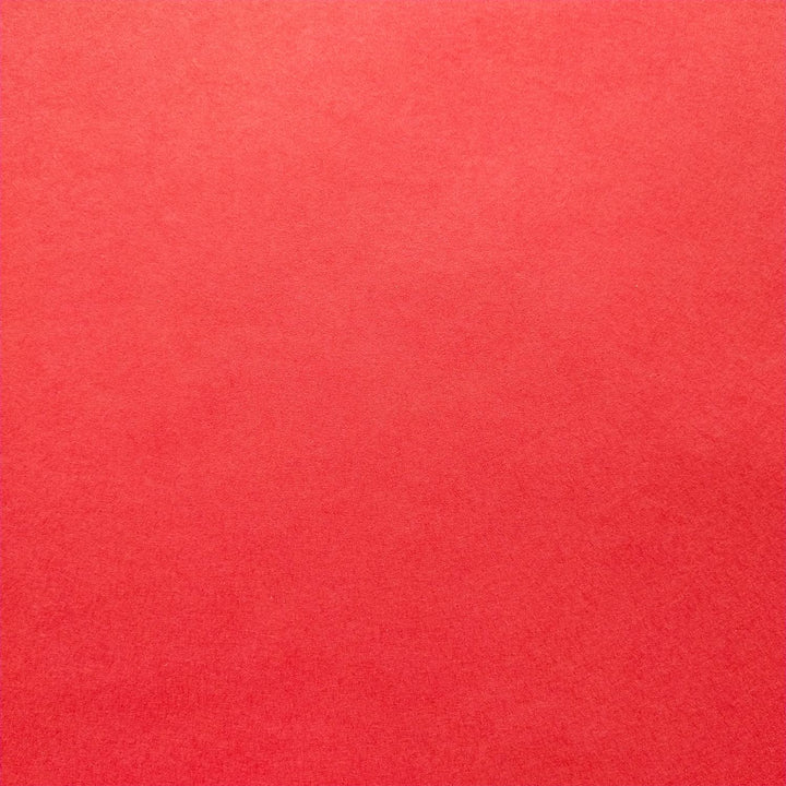 Cherry red mulberry paper by Kozo Studio captured in a close-up, highlighting the soft feel and natural creases of handmade paper.