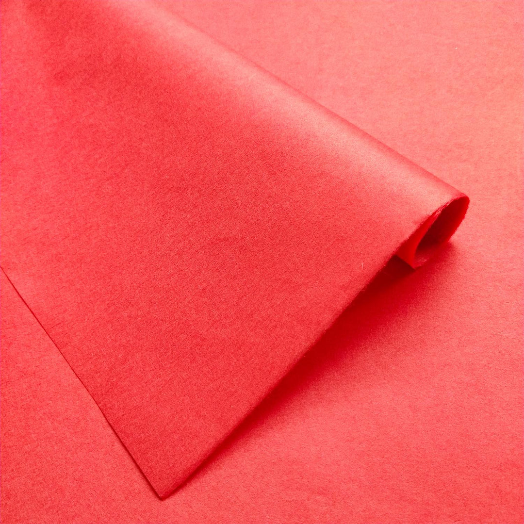 Detailed view of Kozo Studio handmade paper in solid cherry red, featuring the slightly reflective texture of premium mulberry paper.