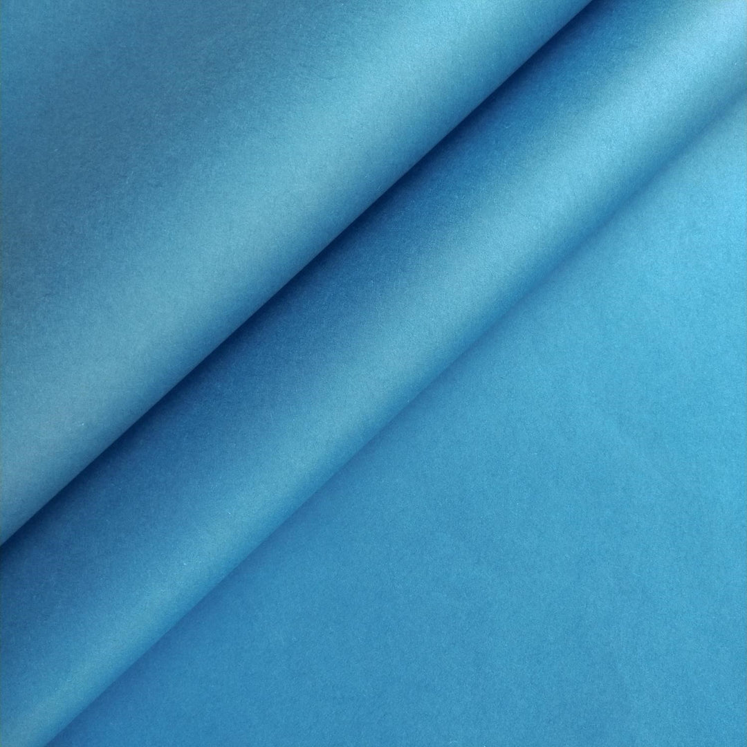 Close-up of cobalt blue mulberry paper sheets from Kozo Studio highlighting the smooth texture and rich handmade paper quality.