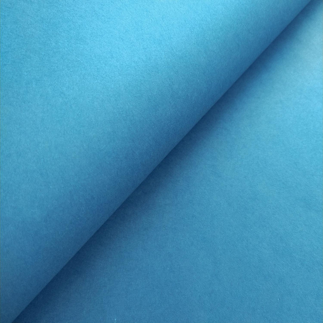 Detailed view of solid-colored Kozo Studio handmade paper in cobalt blue, featuring the elegant texture of authentic mulberry paper.