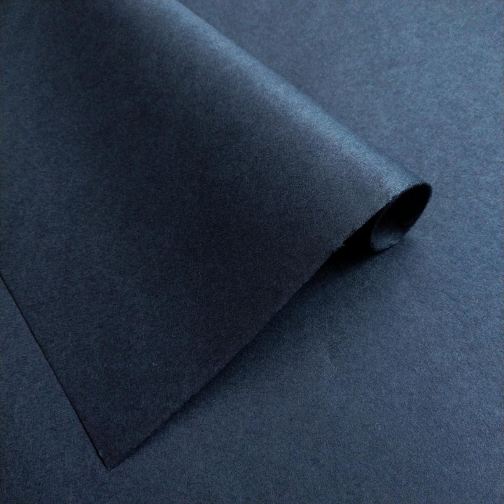 Detailed view of Kozo Studio mulberry paper in solid denim blue, highlighting the soft handmade paper surface.