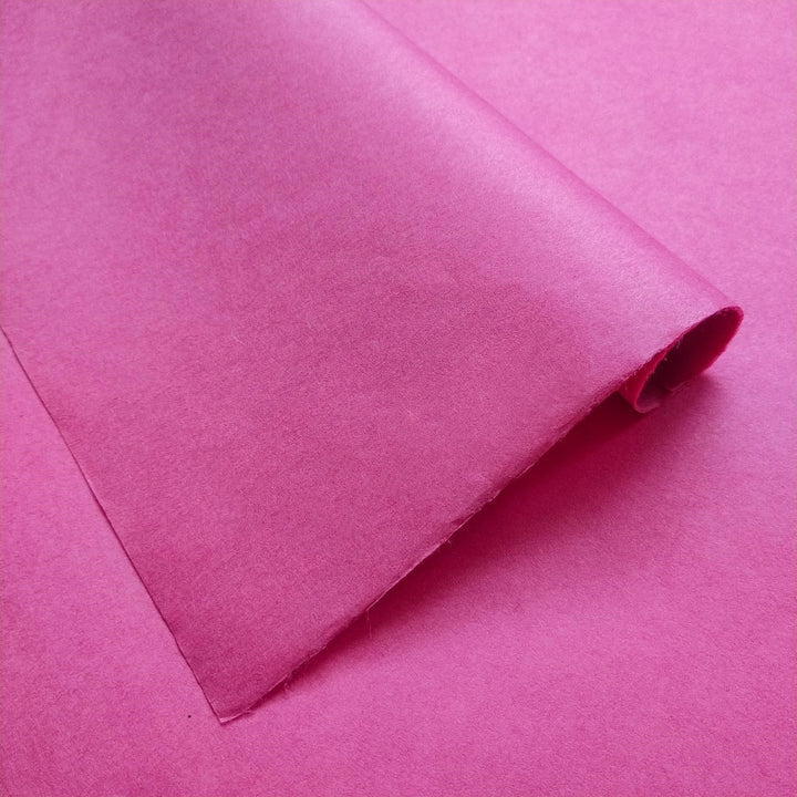 Solid-colored Kozo Studio mulberry paper in fuchsia, featuring a rich gradient and soft shadows that emphasize its handmade quality.