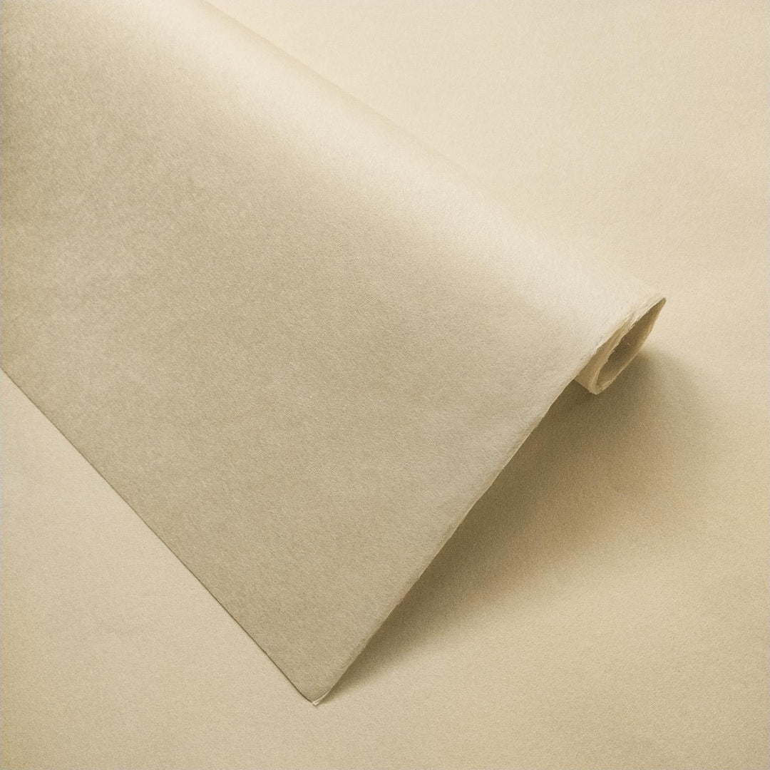 Detailed view of handmade ivory mulberry paper by Kozo Studio with gently folded layers and warm, smooth surface tones.