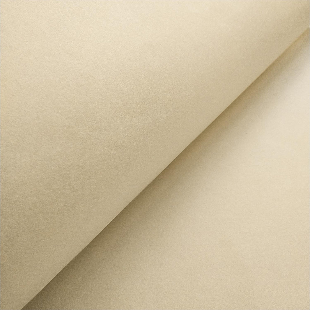 Kozo Studio mulberry paper in ivory shown in a close-up with overlapping folds, displaying the delicate handmade surface and organic finish.
