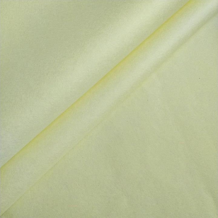 Close-up of lemon yellow handmade mulberry paper from Kozo Studio, showing its smooth texture and soft folds in a diagonal layout.