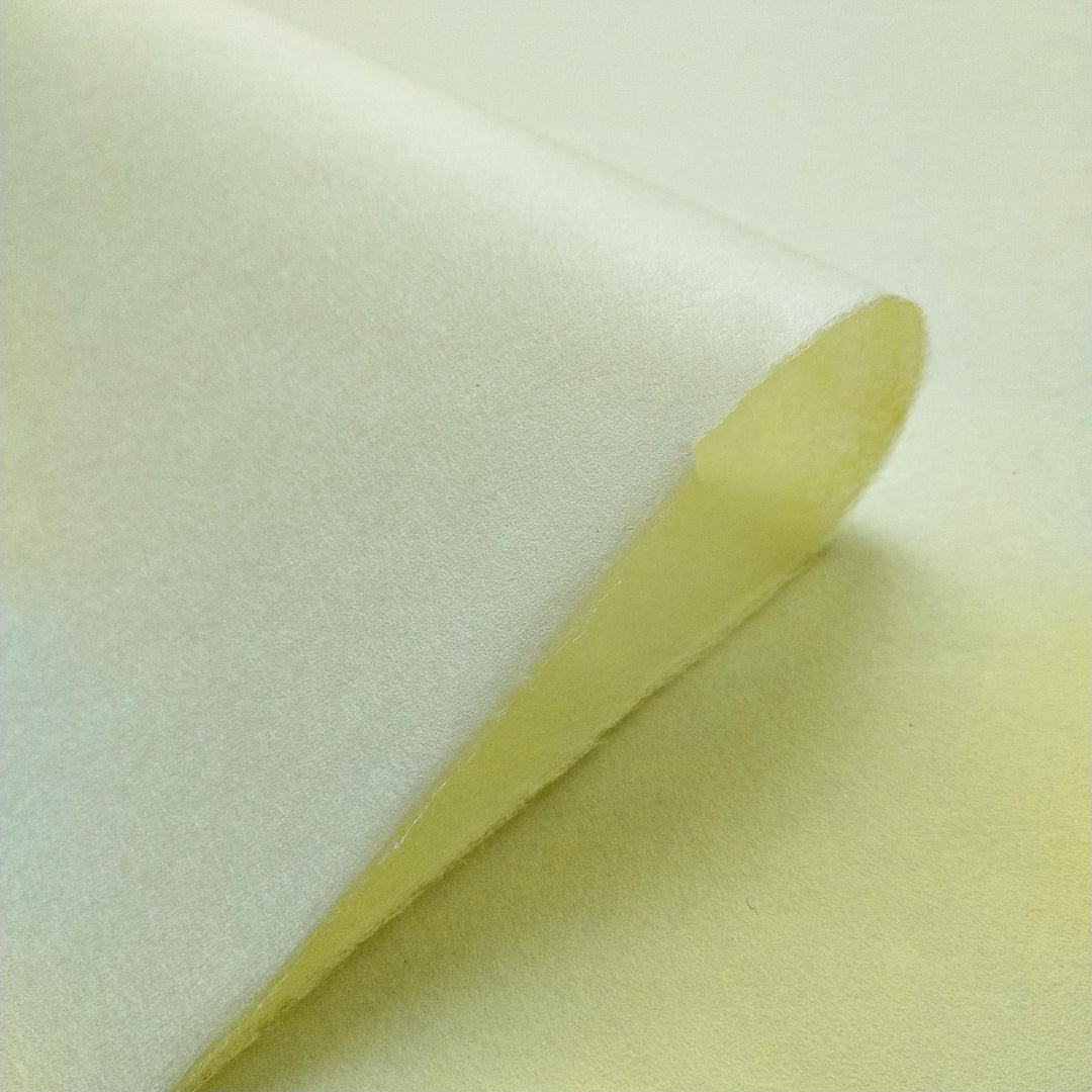 Kozo Studio handmade paper in a vibrant yellow hue, with a close-up view showcasing the smooth finish and natural mulberry texture.