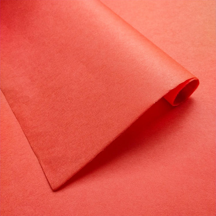 Detailed view of solid-colored Kozo Studio mulberry paper, showing a folded Nasturtium sheet with smooth surface and handcrafted texture.