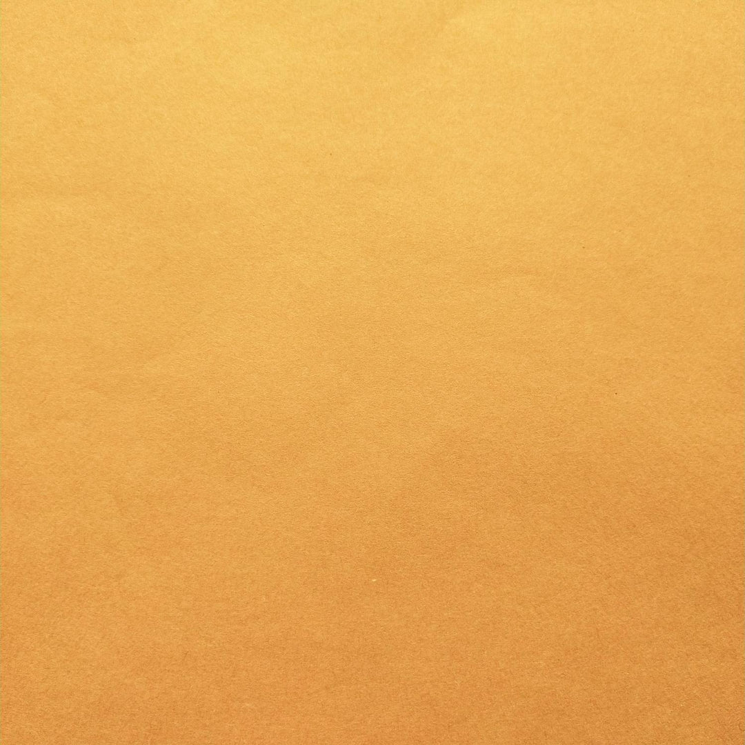Handmade mulberry paper in a vibrant orange hue, displayed in layers to emphasize texture and softness, created by Kozo Studio.