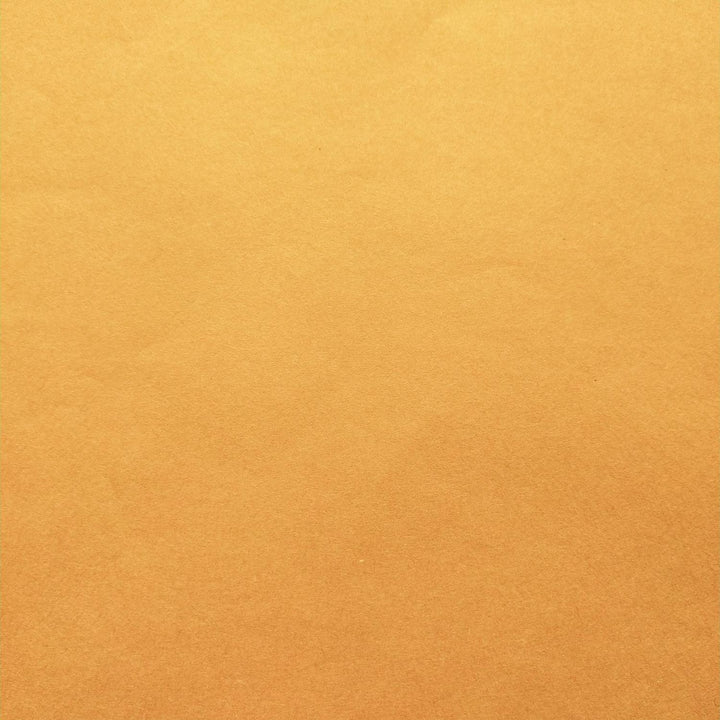 Handmade mulberry paper in a vibrant orange hue, displayed in layers to emphasize texture and softness, created by Kozo Studio.