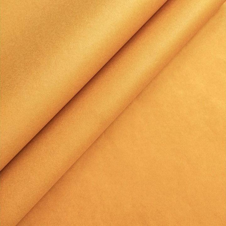 Close-up of orange mulberry paper from Kozo Studio, showcasing the rich texture and soft layers of this handmade paper in a warm earthy tone.