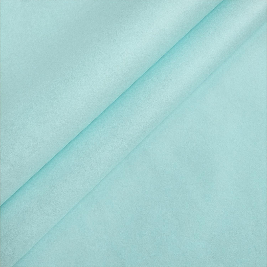 Close-up of sky blue mulberry paper by Kozo Studio, folded to showcase the handmade paper's smooth texture and elegant matte finish.