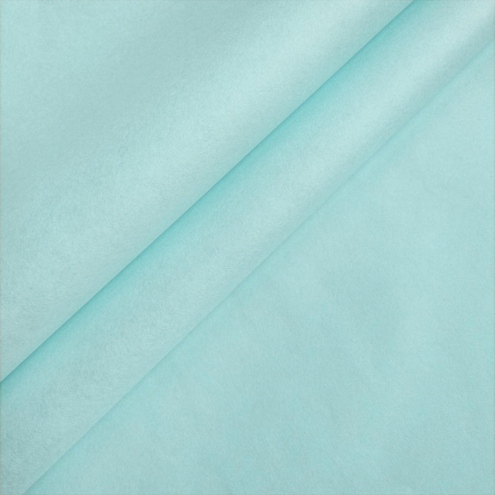 Close-up of sky blue mulberry paper by Kozo Studio, folded to showcase the handmade paper's smooth texture and elegant matte finish.