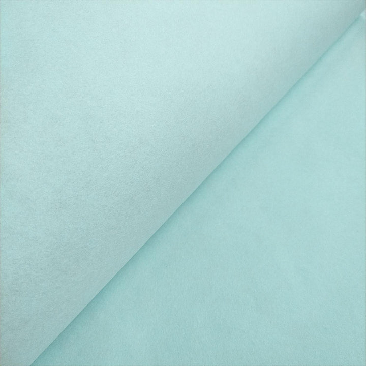 Elegant matte finish of Kozo Studio mulberry paper, shown in a close-up of the sky blue sheet folded for depth and texture.