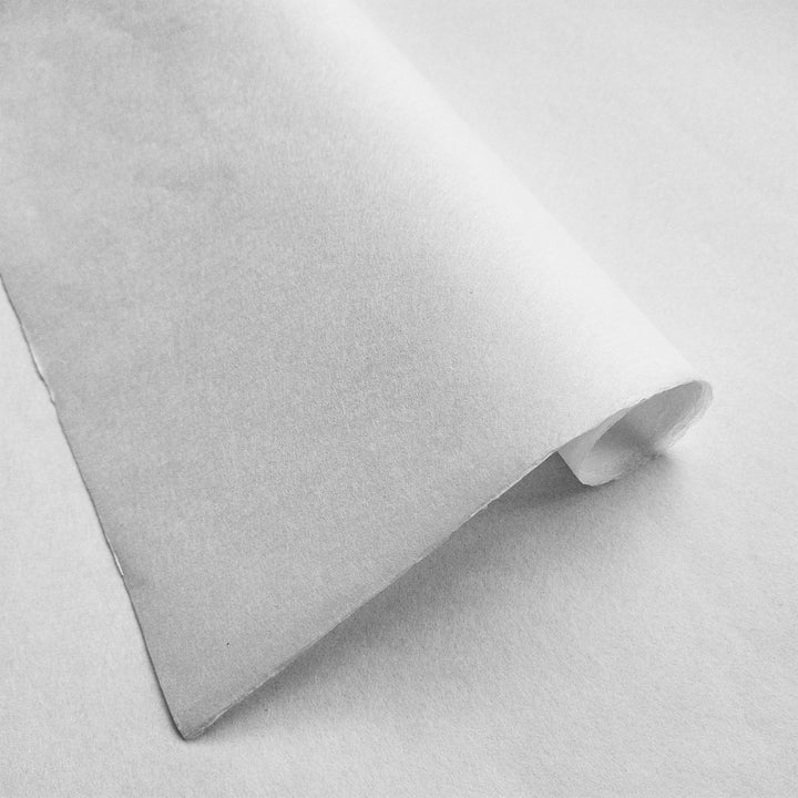 Detailed image of white handmade paper from Kozo Studio highlighting the soft texture of traditional mulberry paper.