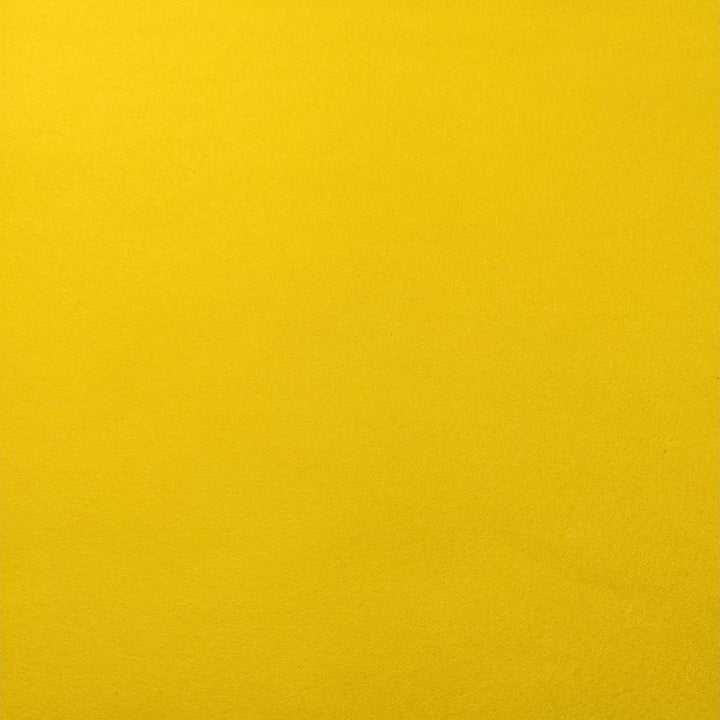 Diagonal fold in Kozo Studio's solid-colored handmade mulberry paper, glowing in bright yellow with subtle layered shading.