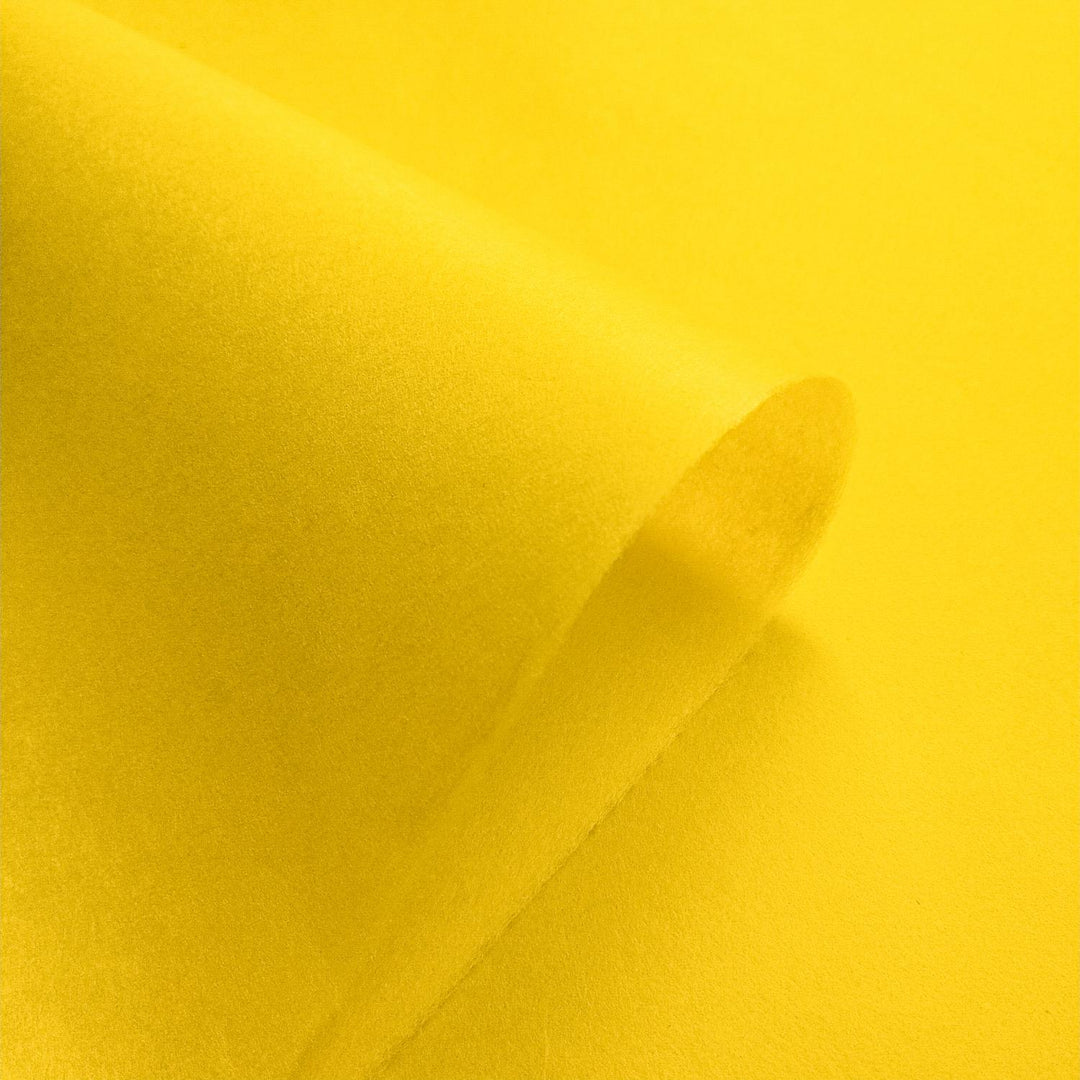 Kozo Studio's yellow mulberry paper, handcrafted with a smooth texture and folded to reveal natural shadows and depth.
