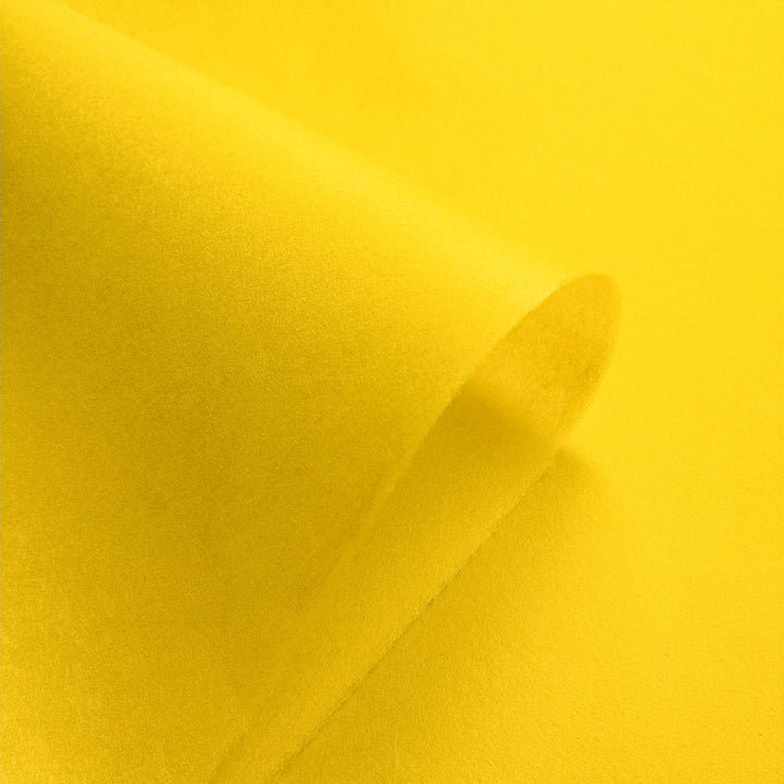 Kozo Studio's yellow mulberry paper, handcrafted with a smooth texture and folded to reveal natural shadows and depth.