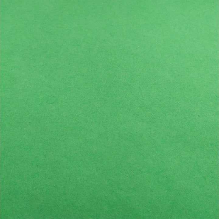 Handmade mulberry paper in forest green by Kozo Studio, neatly folded to reveal its natural fibers and soft, luxurious texture.