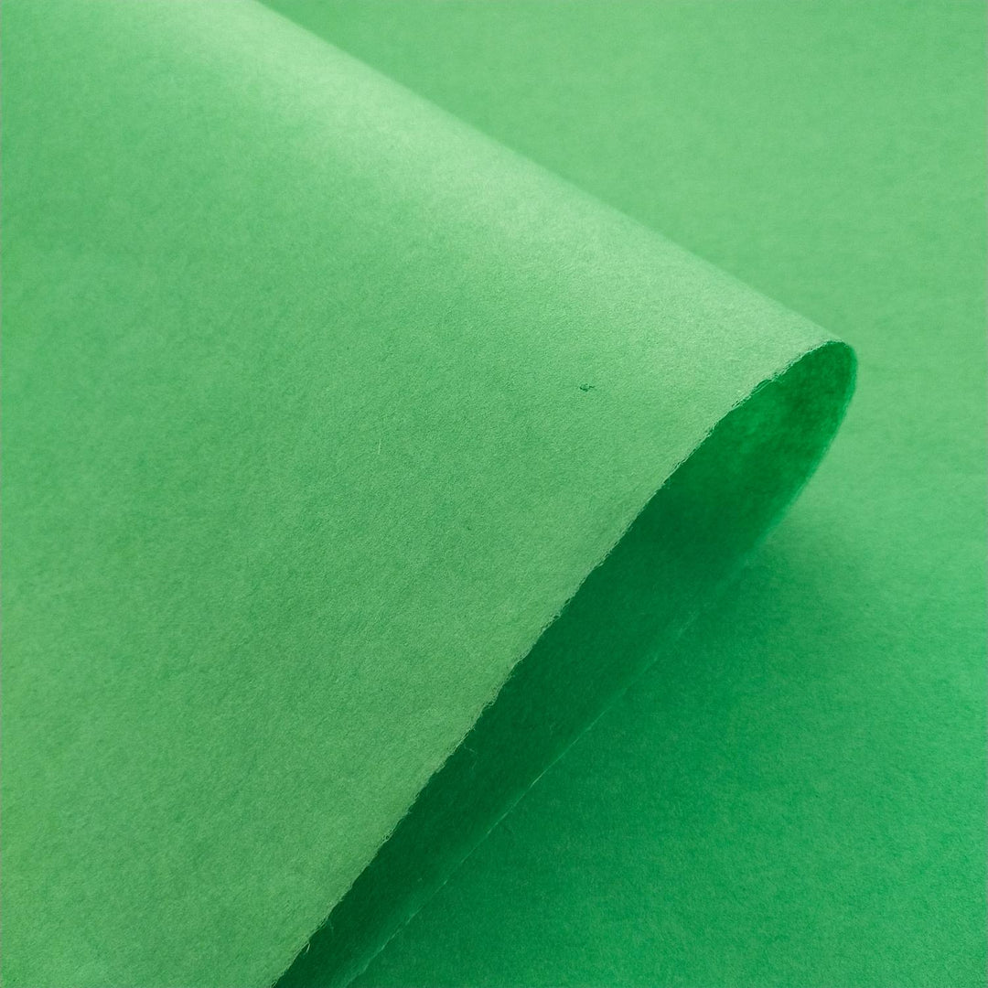 Kozo Studio forest green handmade paper captured in a close-up, emphasizing the subtle shading and premium quality of mulberry paper.