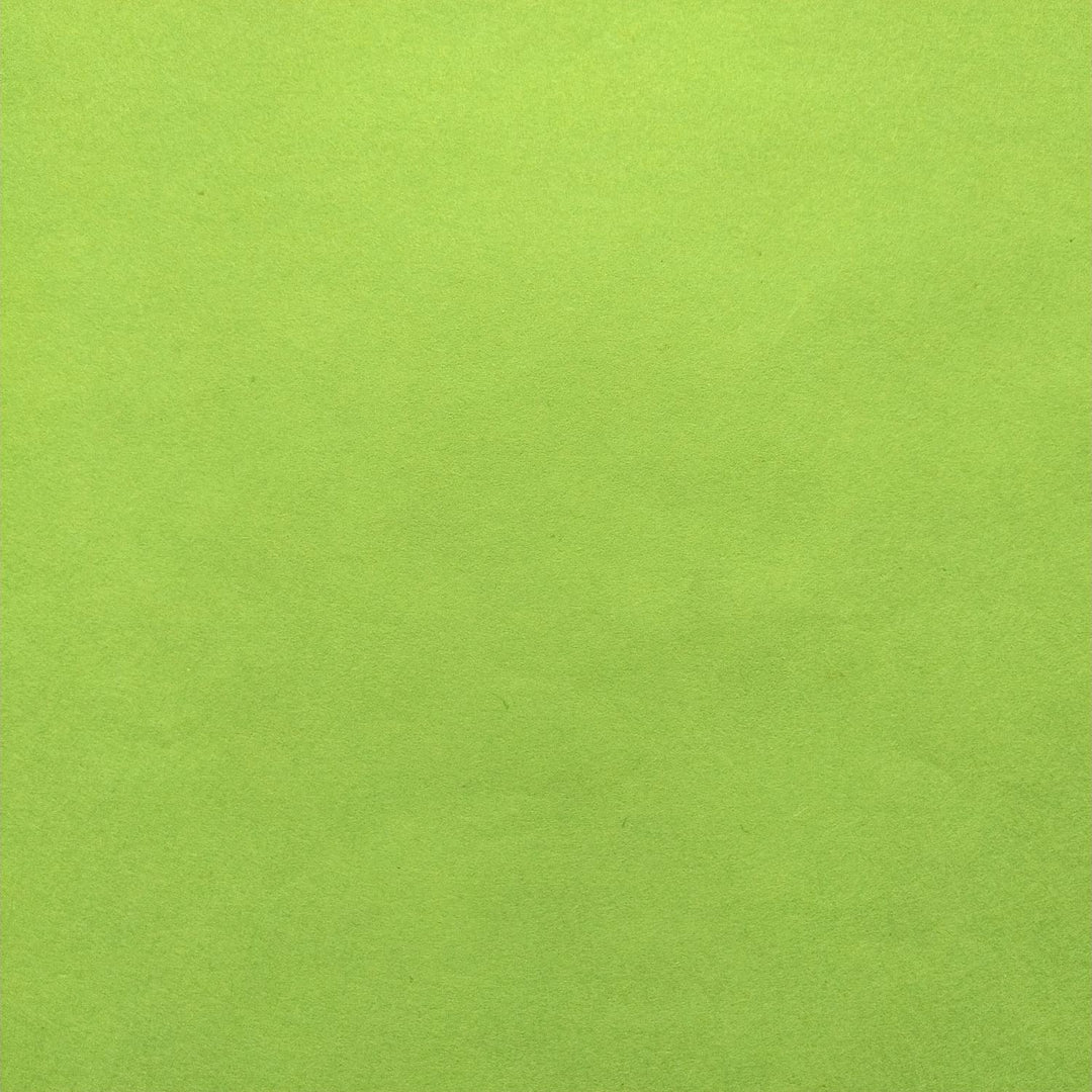 Neatly folded solid-colored handmade paper in olive green from Kozo Studio, highlighting the fine quality of mulberry paper.