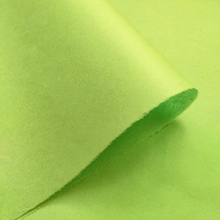 Detailed view of Kozo Studio's olive green mulberry paper, with layered folds that emphasize the smooth handmade paper texture.