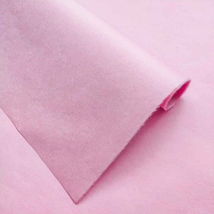 Handmade pink mulberry paper from Kozo Studio with gentle folds and plush rice paper texture under natural light.