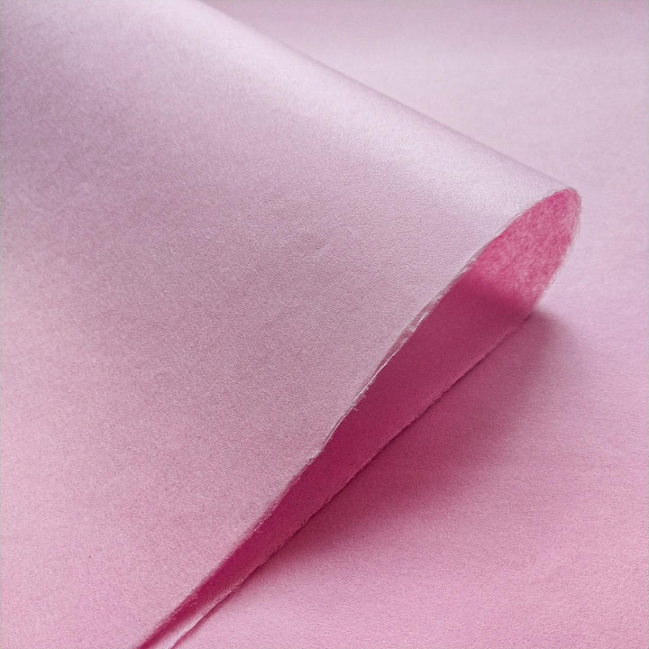 Elegant draping of Kozo Studio mulberry paper in soft pink highlighting the unique texture of handmade paper.