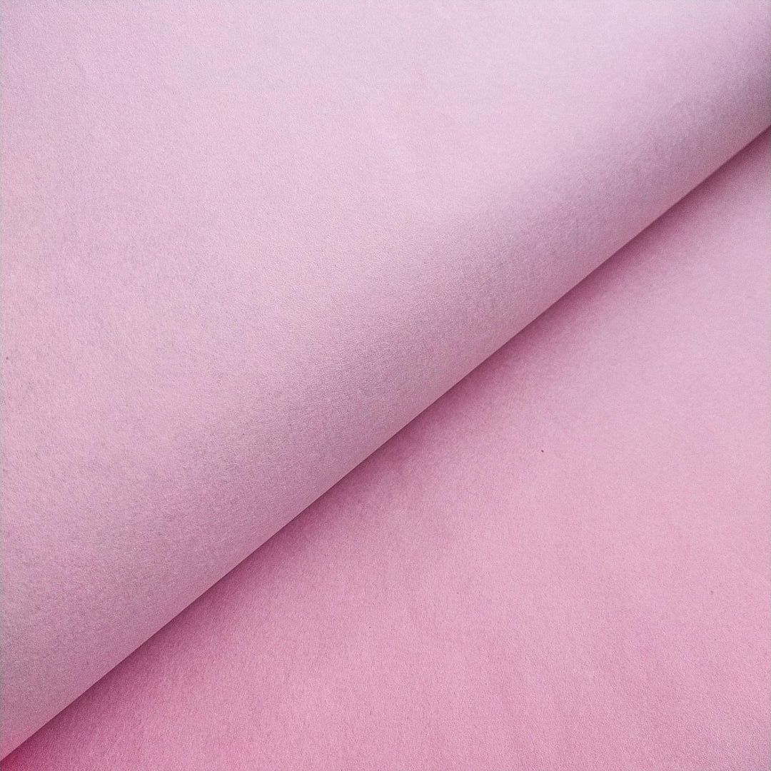 Kozo Studio close-up image of pink mulberry paper featuring its fine, handcrafted texture and curved paper layers.