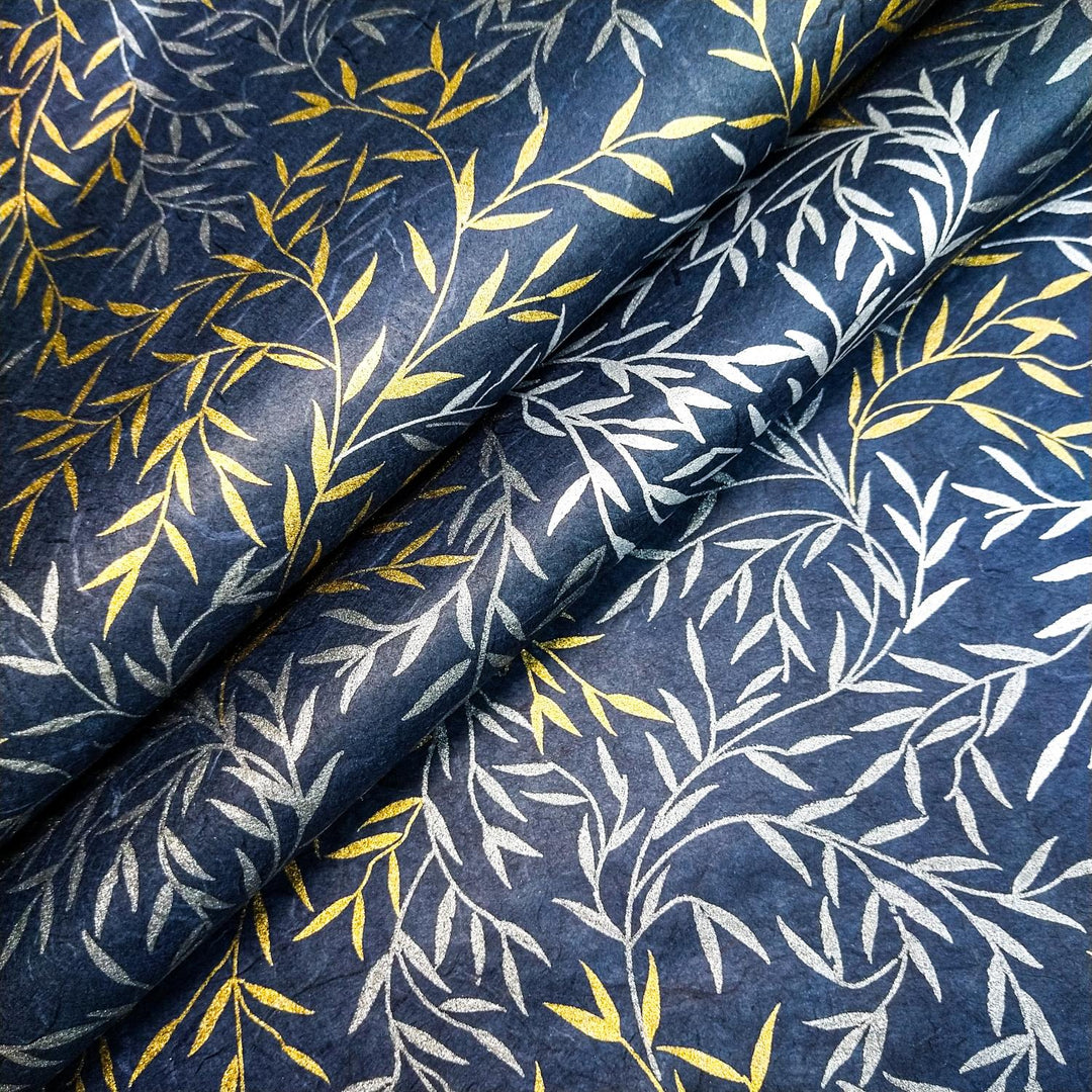 Willow screen-printed handmade paper by Kozo Studio showcasing gold, silver, and white leafy branches on a navy background, inspired by the natural texture of mulberry paper.