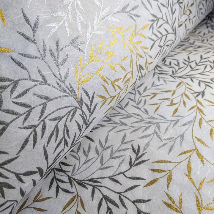 Elegant mulberry paper crafted by Kozo Studio, featuring shimmering metallic prints of leaves in silver and gold on handmade white paper.