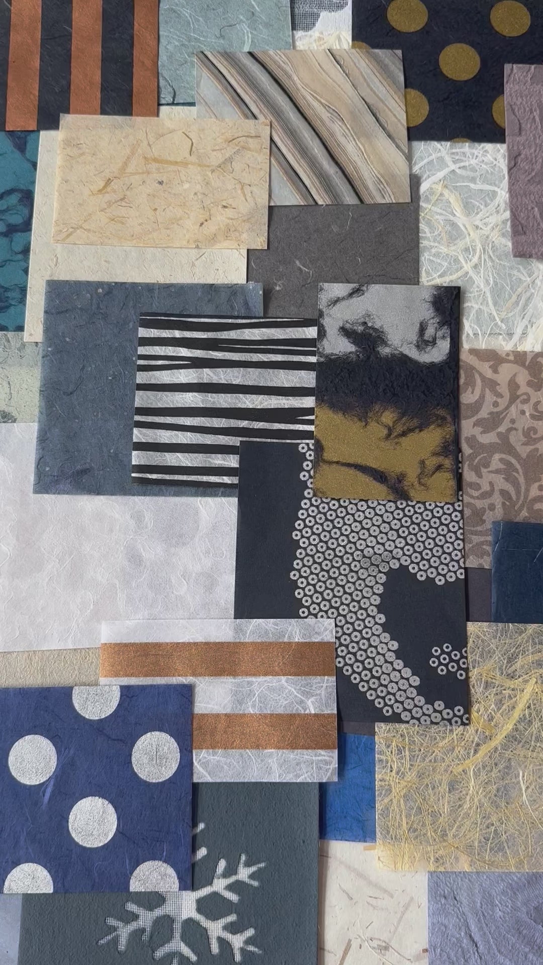 Close-up of assorted handmade mulberry paper pieces from Kozo Studio, featuring a variety of textures and colors in blue, white, and gold, ideal for collage or paper mache art.