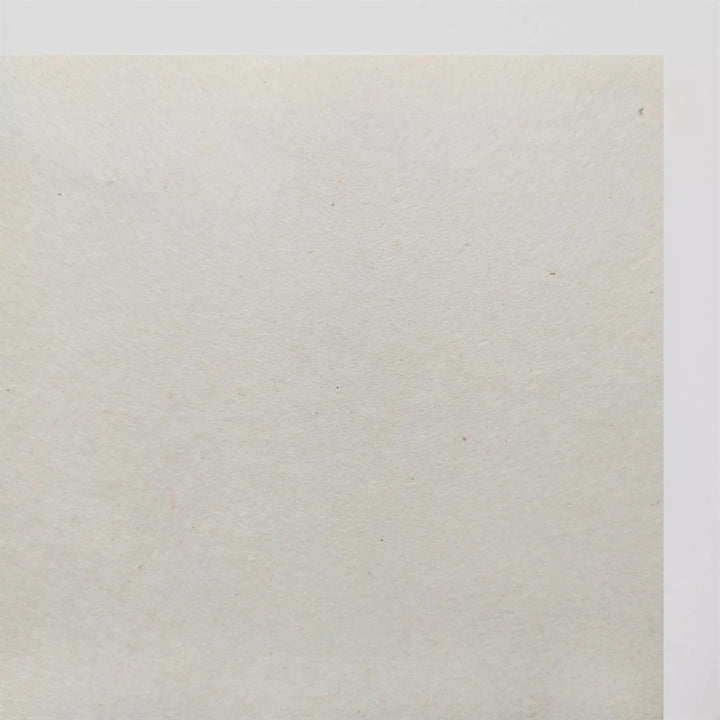 A close-up of Kozo Studios A4 Extra Thin Natural Kozo Paper (35 gsm) reveals its subtly textured, slightly rough surface with barely visible specks against a neutral background.