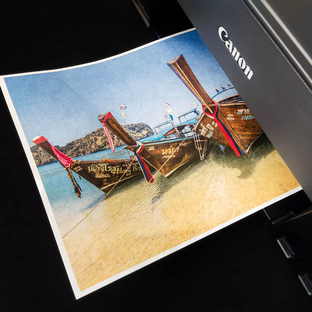 A Canon printer beautifully renders a photo of long-tail boats on a beach using Kozo Studios A4 Thin Natural Kozo Paper (10 sheets, 45 gsm), enhancing the vibrant image with its unique texture.