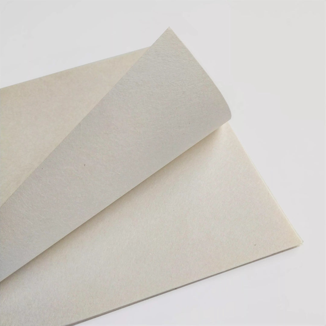 Close-up of two A4 sheets of thin natural mulberry paper from Kozo Studio, showcasing the handmade paper texture and visible fibers on a clean white background.