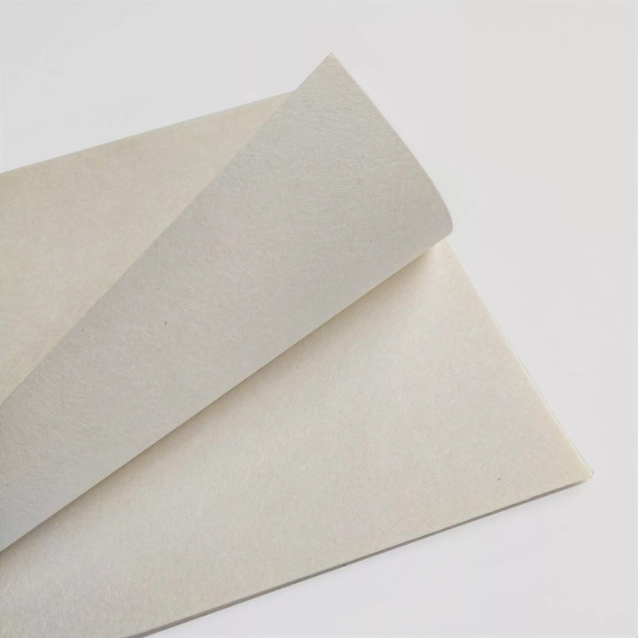 Close-up of two A4 sheets of thin natural mulberry paper from Kozo Studio, showcasing the handmade paper texture and visible fibers on a clean white background.
